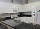 Modern kitchen boasts granite countertops and white cabinetry at 601 Hillside Ave. N # 1623, North Myrtle Beach, SC 29582