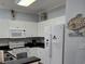 Well-equipped kitchen featuring white cabinetry, granite countertops, and modern appliances at 601 Hillside Ave. N # 1623, North Myrtle Beach, SC 29582