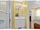 Bright bathroom featuring a white vanity with a mirror and view into the bedroom at 618 3Rd Ave. S # 4D, North Myrtle Beach, SC 29582