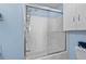 Bright bathroom featuring a white shower and a cabinet for storage at 618 3Rd Ave. S # 4D, North Myrtle Beach, SC 29582
