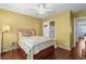 Comfortable bedroom with palm-themed bedding and a side table at 618 3Rd Ave. S # 4D, North Myrtle Beach, SC 29582