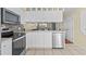 Efficient kitchen featuring stainless appliances, white cabinets, and stylish backsplash at 618 3Rd Ave. S # 4D, North Myrtle Beach, SC 29582
