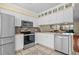 Bright kitchen with stainless steel appliances, white cabinets, and tiled backsplash at 618 3Rd Ave. S # 4D, North Myrtle Beach, SC 29582