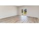 Spacious living room featuring wood-look floors and sliding glass doors at 632 Grateful Dr., Little River, SC 29566