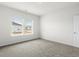 Bright bedroom with neutral carpeting and a window at 847 Cypress Preserve Circle, Longs, SC 29568