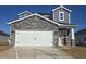 Two-story home with stone accents and a two-car garage at 847 Cypress Preserve Circle, Longs, SC 29568