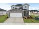 Two-story home with stone accents and a two-car garage at 847 Cypress Preserve Circle, Longs, SC 29568