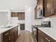 Modern kitchen features stainless steel appliances and white quartz countertops at 847 Cypress Preserve Circle, Longs, SC 29568