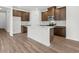 Modern kitchen with island and dark brown cabinets at 847 Cypress Preserve Circle, Longs, SC 29568