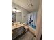 Bathroom with tub shower, vanity, and dolphin decor at 8885 Grove Park Dr. # F, Surfside Beach, SC 29575