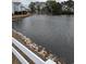Waterfront view with white fence and landscaping at 8885 Grove Park Dr. # F, Surfside Beach, SC 29575