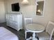 This cheerful bedroom includes a dresser with television, small table and chairs, and comfortable beds at 9550 Shore Dr. # 1226, Myrtle Beach, SC 29572