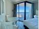 Inviting bedroom features a glass table and chairs and a sliding glass door to an ocean-view balcony at 9550 Shore Dr. # 1226, Myrtle Beach, SC 29572