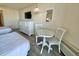 The cozy bedroom features a dresser with television, small table and chairs, and comfortable beds at 9550 Shore Dr. # 1226, Myrtle Beach, SC 29572