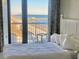 Bright bedroom with access to a beachfront balcony with chairs and a table at 9550 Shore Dr. # 1226, Myrtle Beach, SC 29572