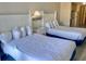 Comfortable bedroom featuring two double beds with access to a kitchenette at 9550 Shore Dr. # 1226, Myrtle Beach, SC 29572