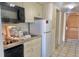 Efficient kitchen features a sink, microwave, refrigerator, and dishwasher, plus access to the hallway at 9550 Shore Dr. # 1226, Myrtle Beach, SC 29572