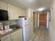 Efficient kitchen includes a sink, microwave, refrigerator, cabinets and a doorway to the hall and entry at 9550 Shore Dr. # 1226, Myrtle Beach, SC 29572