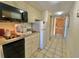 Efficient kitchen features a sink, microwave, refrigerator, and dishwasher, plus a doorway to the entry at 9550 Shore Dr. # 1226, Myrtle Beach, SC 29572
