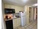 Efficient kitchen features a sink, microwave, refrigerator, and dishwasher, plus access to the hallway at 9550 Shore Dr. # 1226, Myrtle Beach, SC 29572
