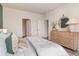 Serene bedroom with white bedding, dresser, and access to hallway at 1129 Black Lake Way, Conway, SC 29526