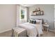 Cozy bedroom with striped bedding, nightstand, and decorative shelves at 1129 Black Lake Way, Conway, SC 29526