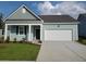 Newly constructed home with light teal siding, white trim, and a two-car garage at 1129 Black Lake Way, Conway, SC 29526