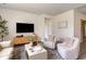 Relaxing living room with two armchairs, a media console, and a large TV at 1129 Black Lake Way, Conway, SC 29526