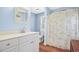 Light blue bathroom with white vanity and hardwood floors at 113 Meeting St., Georgetown, SC 29440