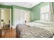 Green bedroom with double bed and hardwood floors at 113 Meeting St., Georgetown, SC 29440