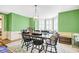 Bright dining room with green walls, built-in bench, and large windows at 113 Meeting St., Georgetown, SC 29440