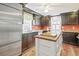 Kitchen with dark wood cabinets, granite countertops, and island at 113 Meeting St., Georgetown, SC 29440