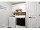 Bright laundry room with white cabinets, modern washer and dryer, and stylish decor at 1141 Bethpage Dr., Myrtle Beach, SC 29579