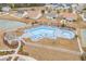 Aerial shot of a community pool featuring lounge chairs and umbrellas, perfect for relaxation at 1141 Bethpage Dr., Myrtle Beach, SC 29579