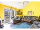 Living room with yellow walls, couches, and access to a balcony at 115 Horizon River Dr. # 8D, Myrtle Beach, SC 29588