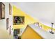 View from the top of the stairs, showing artwork and a yellow wall at 115 Horizon River Dr. # 8D, Myrtle Beach, SC 29588