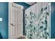 Clean bathroom with teal walls and a shower with a leafy patterned curtain at 116 Emily Springs Dr., Conway, SC 29527