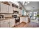 Modern kitchen with granite countertops, stainless steel appliances, and light wood flooring at 116 Emily Springs Dr., Conway, SC 29527