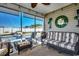 Screened porch with striped couch and wicker chairs at 116 Emily Springs Dr., Conway, SC 29527