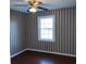 Bedroom with hardwood floors and striped wallpaper at 1203 Sharon Ave., Marion, SC 29571