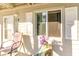 Inviting porch with a chair, potted flowers, and a view of the woods at 1280 White Tree Ln. # G, Myrtle Beach, SC 29588