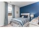 Bright bedroom with blue accent wall, striped bedding, and natural light at 1481 Nokota Dr., Conway, SC 29526