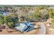 An aerial view of a home with a boat in the yard, an attached garage, and mature trees at 16 Johnstone Ln., Georgetown, SC 29440