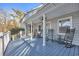 Inviting covered back porch with rocking chairs and a peaceful setting at 16 Johnstone Ln., Georgetown, SC 29440