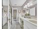 Bright bathroom featuring a double sink vanity, neutral tile, and a glass-enclosed shower at 16 Johnstone Ln., Georgetown, SC 29440