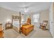 Bright bedroom with hardwood floors, a comfortable bed, and a rocking chair at 16 Johnstone Ln., Georgetown, SC 29440