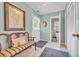 Bright entryway with blue accent wall, white tile floor, and bench seat at 16 Johnstone Ln., Georgetown, SC 29440