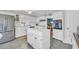 Galley kitchen with white cabinets, island, and stainless steel appliances at 16 Johnstone Ln., Georgetown, SC 29440