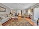 Cozy living room featuring a decorative fireplace, wood floors, and neutral furniture at 16 Johnstone Ln., Georgetown, SC 29440