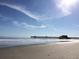 Serene beach scene with a pier extending into the ocean under a clear sky at 175 Saint Clears Way # 23A, Myrtle Beach, SC 29572